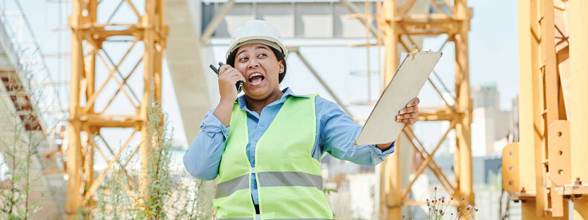 An engineer at a dock using a walkie-talkie.